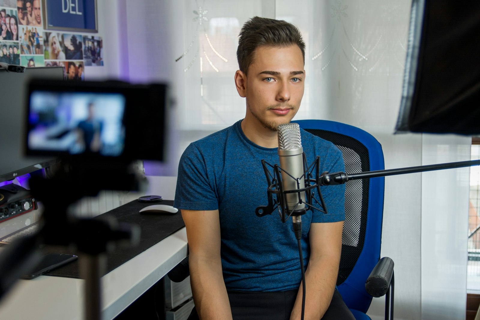 Podcasting microphone on a boom arm in a home studio
